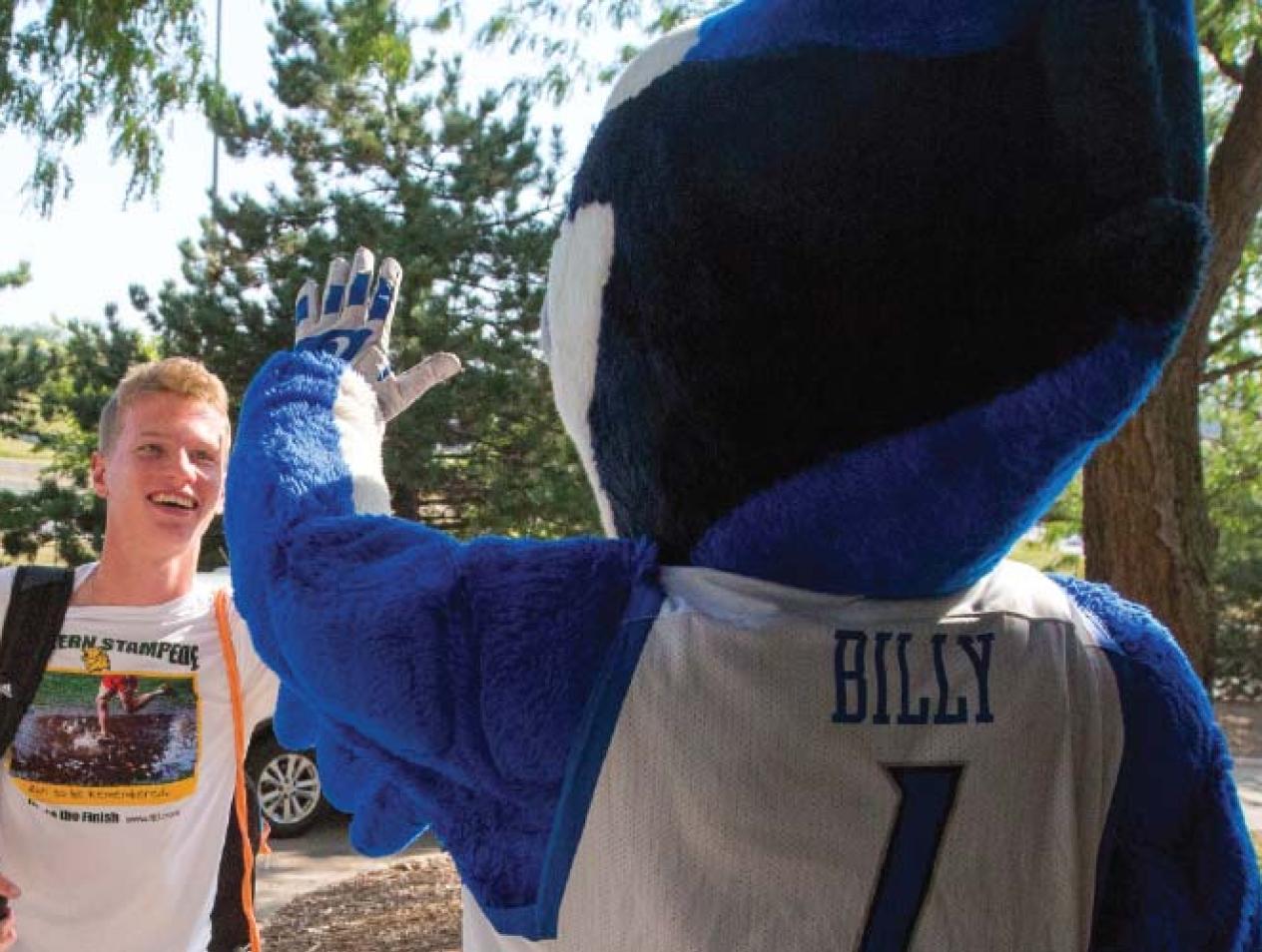 Creighton student high fives Billy Bluejay