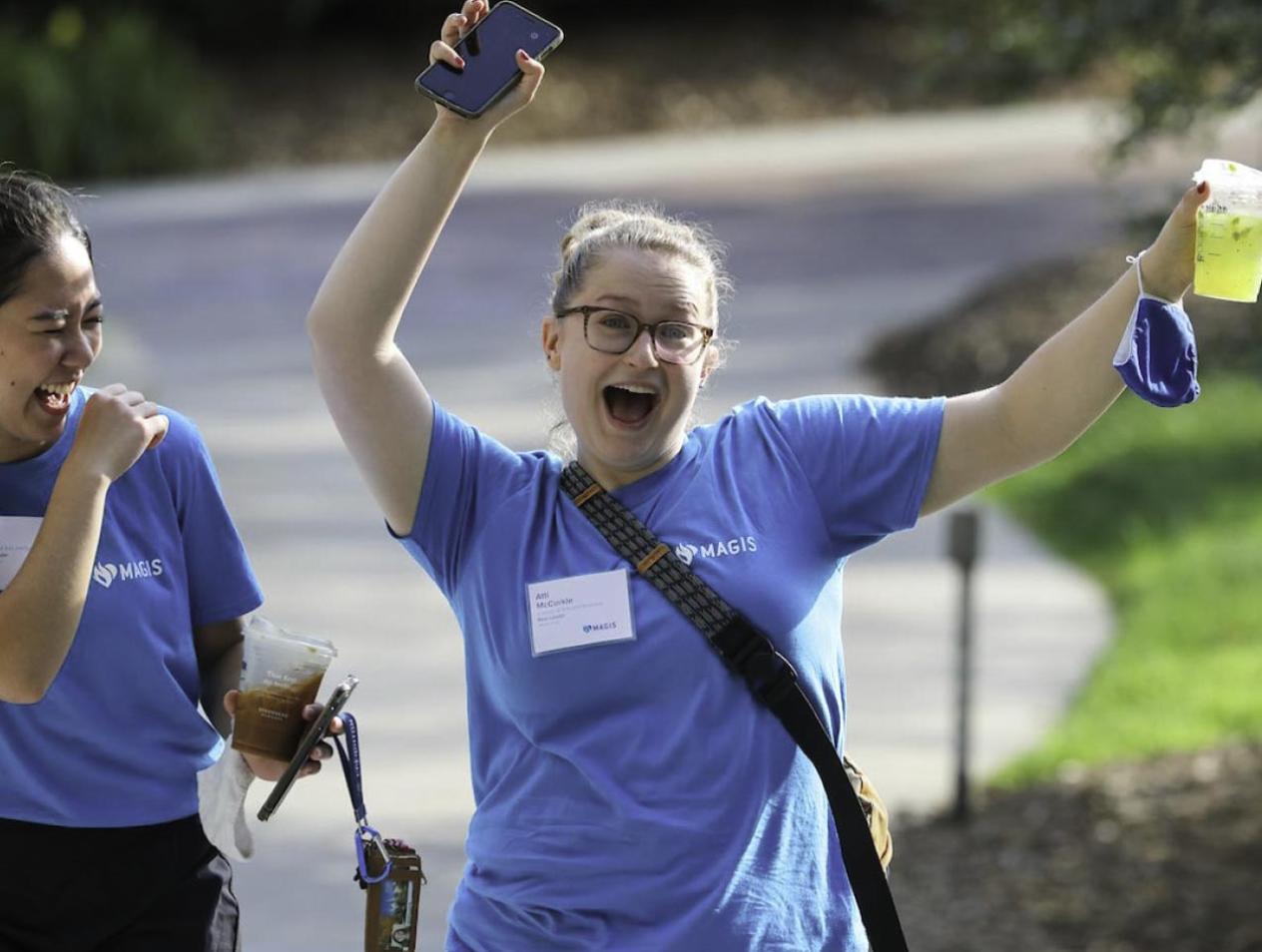 Student smiling and laughing while moving in Creighton.